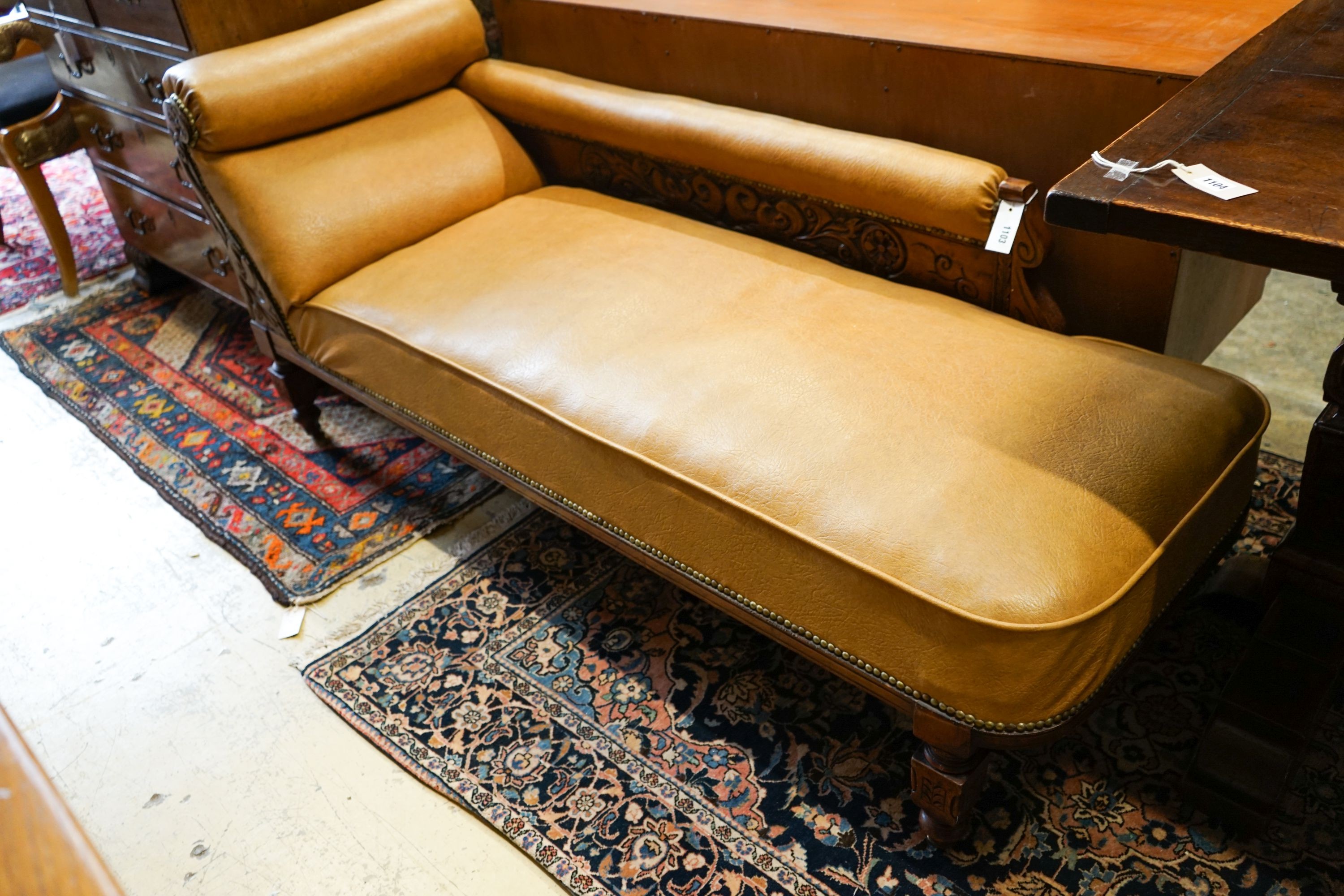 A late Victorian carved mahogany chaise longue with rexine upholstery, length 175cm, depth 60cm, height 74cm